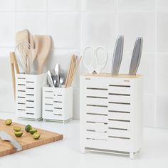 kitchen utensils and cutting boards on a counter