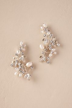 two pairs of pearl and crystal bridals on a beige background with copy space for text