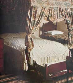 an old photo of a bedroom with a bed and canopy over the headboard in it