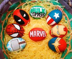 an easter basket filled with painted rocks that spell out superheros