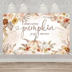 a wall hanging on the side of a room with a pumpkin and flowers in it