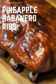 a close up of meat on a cutting board with the words pineapple habanero ribs