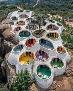 an aerial view of a building made out of concrete and colorful circles on the roof