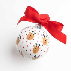 a white ornament with reindeers on it and a red ribbon around the top