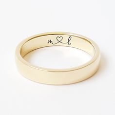 a gold wedding band with the word i'm all written on it and a heart