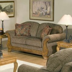 a living room with two couches and lamps on the table in front of them