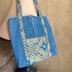 a blue purse sitting on top of a chair