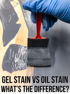 a person using a sponge to clean the surface of a piece of metal with black paint on it