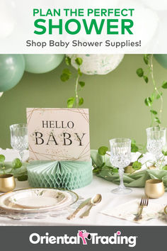 a baby shower is set up with balloons and greenery on the table for a baby shower