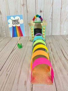 this is an image of a paper tube craft with rainbows and crowns on it