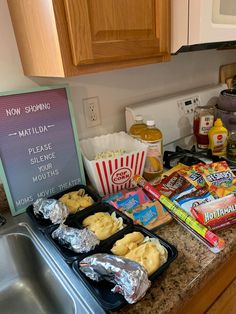 some food is sitting on the counter next to a sign that says mostly all except candy and cookies