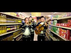 two men are playing instruments in a grocery store while another man plays the guitar behind them