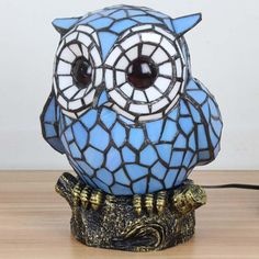 an owl lamp sitting on top of a wooden table