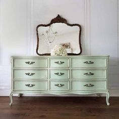 an antique dresser with a mirror on top