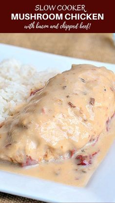 a white plate topped with meat covered in gravy and rice next to a fork