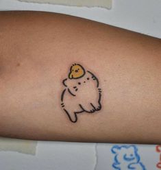 a small tattoo on the arm of a person with a dog in it's head