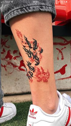 a person with a tattoo on their leg that has chinese writing in the middle of it