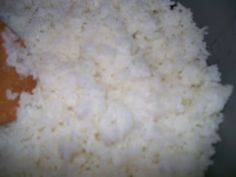 rice and sauce are mixed together in a bowl