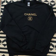 cotton/poly black crewneck sweatshirt with gold embroidery. unisex adult sizing. these are made to order! please allow 2-4 weeks for shipment ᵕ̈ model is 5'5, usually a size small & wearing a size large. Chanel Crewneck, Chanel Sweatshirt, Chanel Sweater, White Crewneck Sweatshirt, Black Crewneck Sweatshirt, Vegas Outfit, Designer Sweatshirts, Chanel Inspired, Cute Shirt Designs