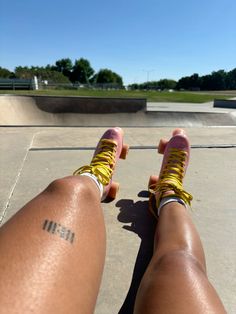 a person riding a skateboard with their feet on the ground in front of a ramp