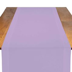 a wooden table topped with a purple runner