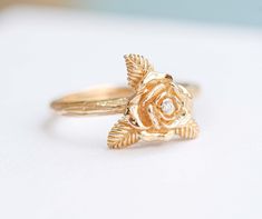 "ღ Immediately fell in love with!. This Rose Flower ring, This ring carved shaped as a rose flower and was also decorated with Natural Diamond and were elaborately installed on the ring by skilled craftsmen, On the surface wood carving pattern. Which makes this ring definitely unique. ♦ Description Product ♦ ✦ MAIN STONE DETAIL ✦  ➤  Main Stone : Natural Diamond ➤ Size: 1.3 mm ➤ Weight : 0.01 carats ➤  Clarity : VVS ➤ Shape : Round ➤  Color : D color  ➤ Cut Grade : Belgium Cut ✦ FLOWER SIZE  ✦ BAND DETAIL ✦ ➤  Flower Size : 7.0 mm ➤ Band Width：1.8 mm ➤ Band Thickness : 1.5 mm ✦ MATERIAL ✦ WEIGHT ✦ ➤ Material Gold : 10K Gold , 14K Gold , 18K Gold ➤ Rose Gold - Yellow Gold - White Gold ( Plated Rhodium ) /  Platinum 950 ➤ Weight of Gold : 10K Gold ➢ 2.0 - 2.5 Gram , 14K Gold ➢ 2.6 - 3.0 Gram Delicate Flower Ring With Rose Cut Diamonds For Wedding, Rose Design Flower Ring For Anniversary, Heirloom Rose Gold Flower Ring For Anniversary, Elegant Gold Rings With Rose Details, Rose Design Flower Ring For Promise, Luxury Flower Shaped Ring For Wedding, Fine Jewelry Rose Design Flower Ring For Promise, Heirloom Rose Gold Flower Ring For Promise, Gold Flower Ring For Proposal