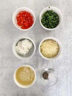 four bowls filled with different types of food on top of a white countertop next to each other