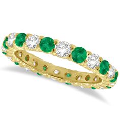 a yellow gold ring with emeralds and diamonds