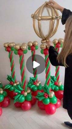 a woman standing in front of some christmas decorations