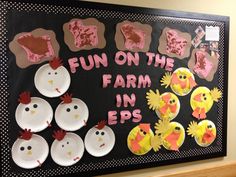 a bulletin board decorated with paper plates and farm animals on it's blackboard