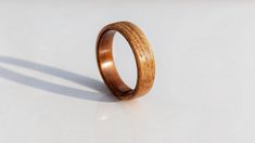 a wooden ring sitting on top of a white surface