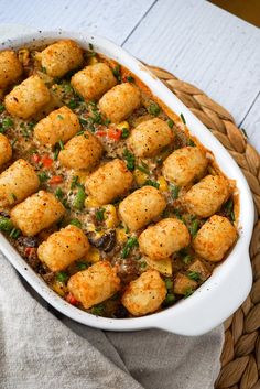 a casserole dish filled with tater tots and vegetables