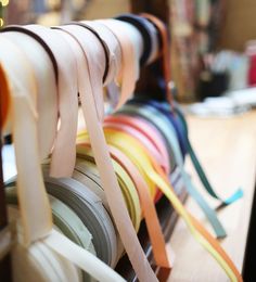 several rolls of ribbons are hanging on a rack