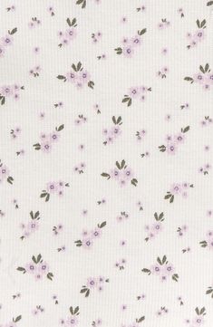 a white fabric with purple flowers on it