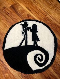 a black and white rug with a silhouette of two people holding hands