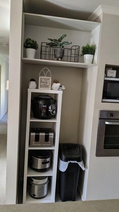 a kitchen with an oven, coffee maker and other items in the corner next to it