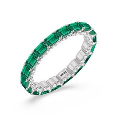 This eternity ring showcases a stunning balance between vintage glamour and feminine romance. It features emerald-cut created Emerald in an east-west setting evoking Art Deco's architectural splendor. Each emerald-cut diamond is set on a thick U-shaped prong punctuated by a pair of petite round diamonds on its side. The curved yellow gold prongs form a circle and makeup the graceful, scalloped base of the band. Elegant Green Diamond Eternity Band, Luxury Eternity Band With Baguette Cut Gemstone, Luxury Stackable Emerald Cut Emerald Ring, Luxury Gemstone Baguette Cut Eternity Band, Luxury Stackable Emerald-cut Emerald Ring, Luxury Baguette Cut Gemstone Eternity Band, Luxury Diamond Emerald Stackable Ring, Elegant Stackable Emerald-cut Eternity Band, Elegant Emerald-cut Gemstone Eternity Band