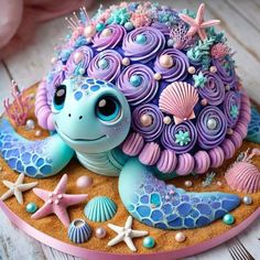 a cake made to look like a turtle with sea shells on it's back