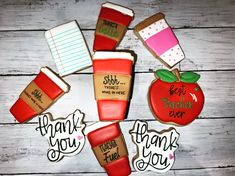 decorated cookies are arranged in the shape of an apple, coffee cup and teacher's day message