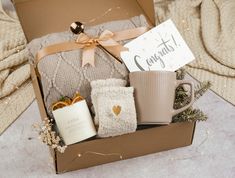 a gift box with coffee mugs and blankets