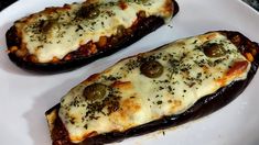 two stuffed eggplant halves on a white plate