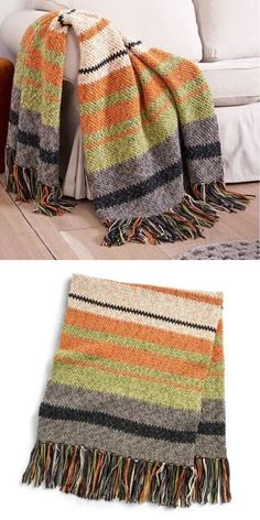 a blanket that is sitting on the floor next to a couch with pillows and blankets