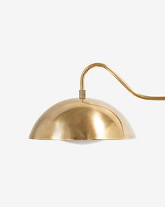 a brass colored lamp on a white background