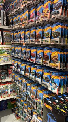 there are many hot wheels toys on display in the toy store and it's price is $ 3 99