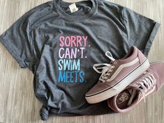 a pair of sneakers and a t - shirt that says sorry can't swim meets