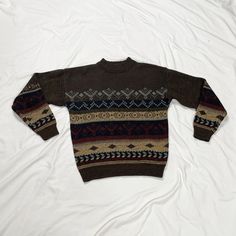 Vintage 1980s long sleeve brown knit sweater. In good vintage condition. Note: I try to match colors as much as possible to pictures but there is a possibility it won't be an exact match. Unless the color is completely incorrect I am unable to offer refunds for this reason. Size: men's medium Brand is The Men's Store at Sears Measurements (taken on garment laid flat): Armpit to armpit: 23" Waist: 40" Shoulder to shoulder: 22" Armpit to hem: 17" Length (top of neck to bottom hem): 25.5" Fabric: 100% acrylic Casual Brown Fair Isle Pattern Sweater, Brown Knitted Long Sleeve Sweater, Cozy Brown Crew Neck Sweater, Vintage Brown Long Sleeve Sweater, Retro Brown Sweater For Fall, Vintage Long Sleeve Brown Sweater, Brown Knitted Crew Neck Sweater, Brown Fair Isle Pattern Winter Sweater, Brown Fair Isle Winter Sweater