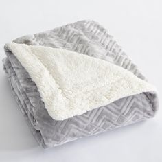 an image of a blanket that is on the ground with a white and gray color scheme