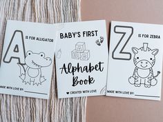 two baby's first alphabet books on a blanket