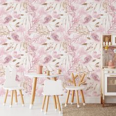 a pink floral wallpaper with wooden chairs and tables in front of it on the floor