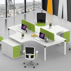 an office with green and white furniture in front of a large window